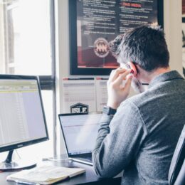 Man performing social listening research on a laptop in an urban office