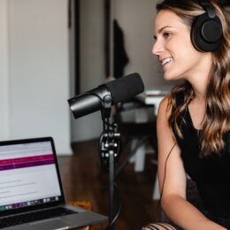 A woman recording a podcast in a studio